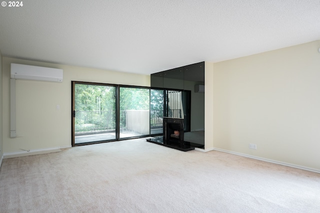 unfurnished room with a wood stove, a textured ceiling, light colored carpet, and a wall mounted air conditioner