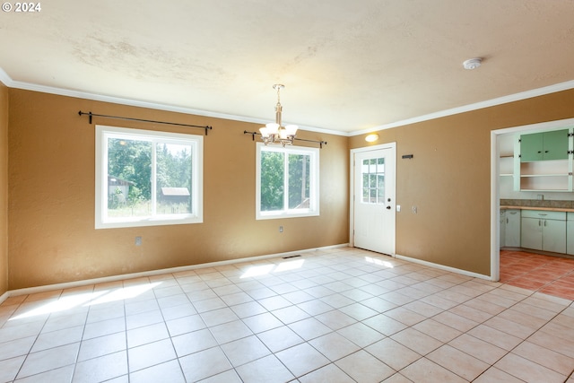 tiled empty room with crown molding and an inviting chandelier