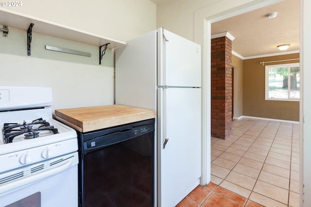 kitchen with white appliances, crown molding, and light tile patterned floors