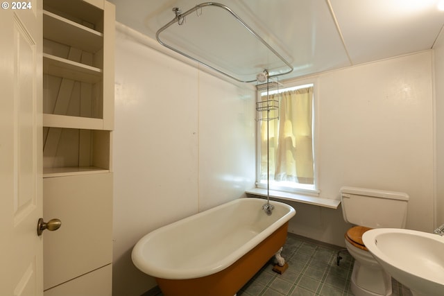 bathroom with sink, toilet, and a tub