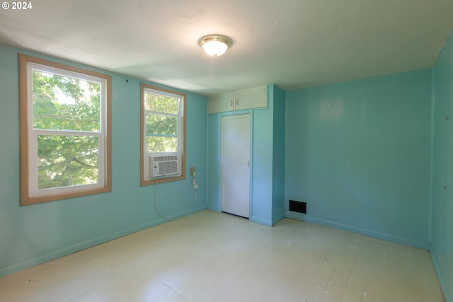 unfurnished bedroom featuring a closet and cooling unit