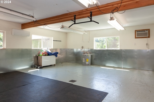 garage featuring electric water heater and a wall unit AC