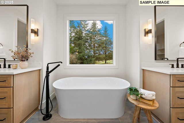 full bath featuring tile patterned flooring, a soaking tub, and two vanities