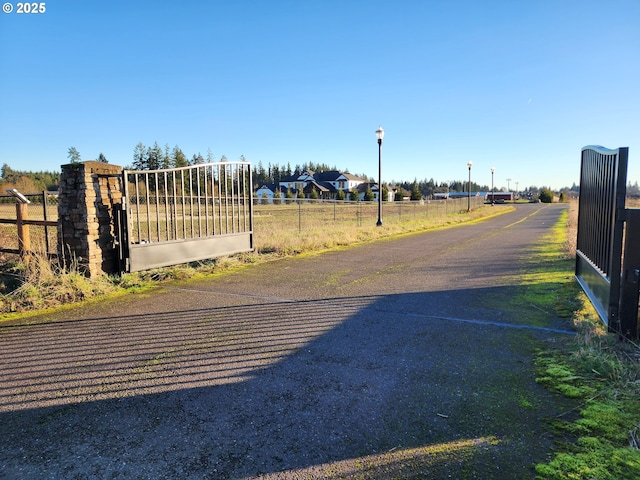 view of road featuring a gate and a gated entry