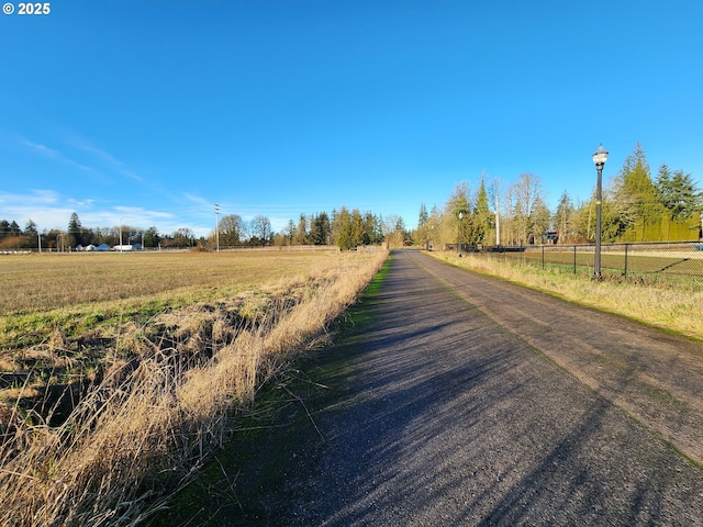 view of street with street lights and a rural view