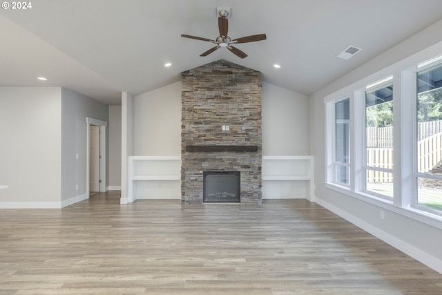 unfurnished living room with plenty of natural light, lofted ceiling, and light hardwood / wood-style flooring