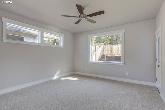 empty room with carpet flooring and ceiling fan