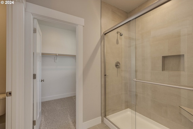 bathroom with a shower with door