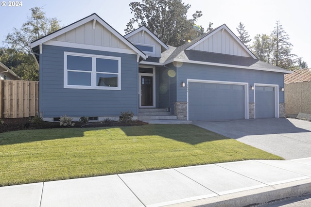 craftsman inspired home with a garage and a front lawn