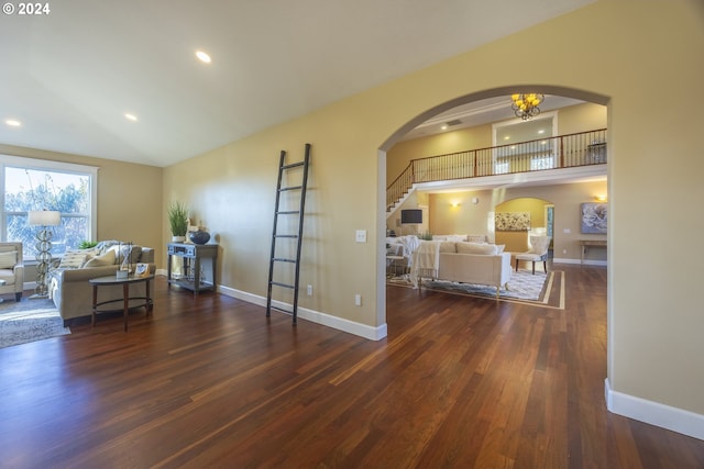 interior space featuring dark hardwood / wood-style floors, high vaulted ceiling, and a notable chandelier