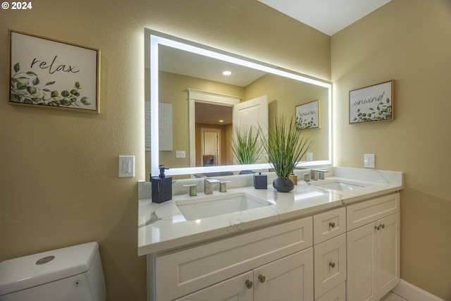 bathroom with vanity and toilet