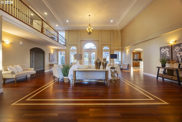 12989 SE Mountain Gate Rd, Happy Valley, OR 97086 - living area with arched walkways, a high ceiling, hardwood / wood-style floors, a chandelier, and ornamental molding