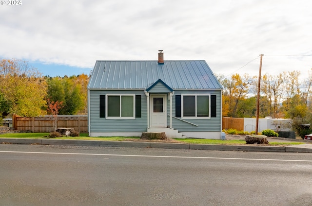 410 N Mountain Blvd, Mount Vernon, OR 97865 - view of front of house with fence, a chimney, metal roof, and entry steps