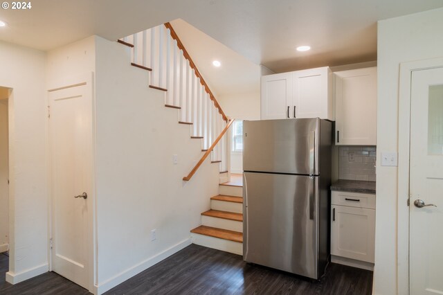 kitchen featuring white cabinetry, stainless steel fridge, backsplash, and dark hardwood / wood-style floors