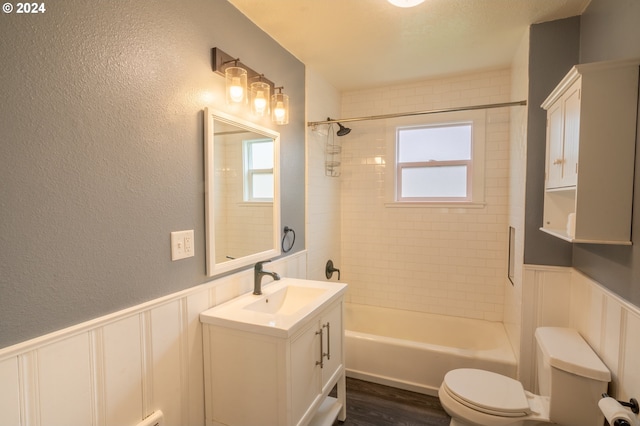 full bathroom featuring toilet, hardwood / wood-style flooring, vanity, and a wealth of natural light