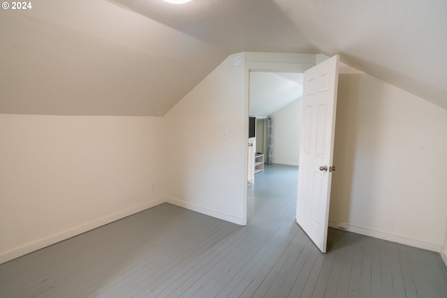 bonus room featuring dark hardwood / wood-style floors and vaulted ceiling