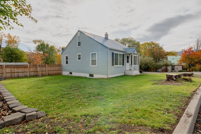 410 N Mountain Blvd, Mount Vernon, OR 97865 - view of side of property with fence, a chimney, a lawn, and metal roof