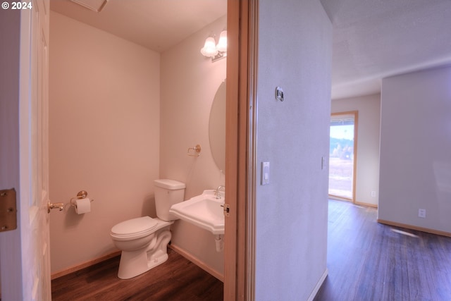 bathroom with wood-type flooring, sink, and toilet