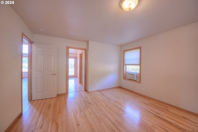 spare room with cooling unit and light hardwood / wood-style floors