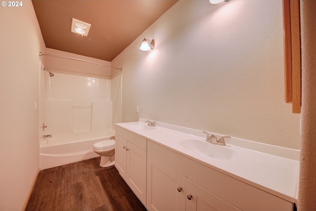 full bathroom featuring tub / shower combination, hardwood / wood-style flooring, vanity, and toilet