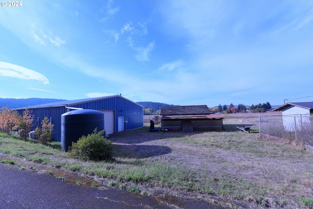 view of side of property with an outbuilding and a garage