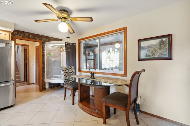 dining room with a wealth of natural light, ceiling fan, and light tile flooring