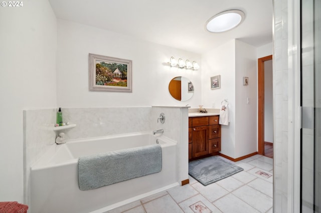 bathroom with tile floors, a washtub, and vanity