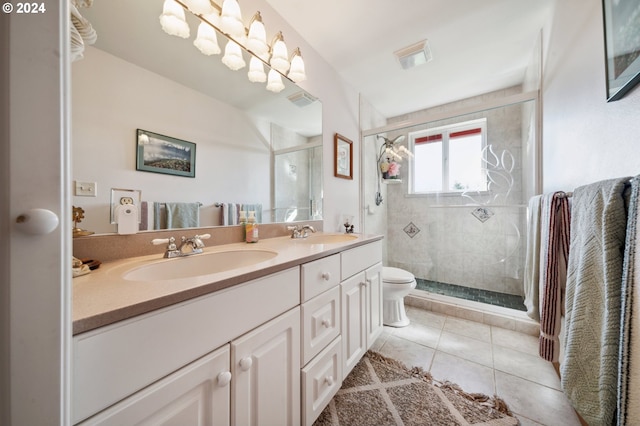 bathroom with dual bowl vanity, tile flooring, toilet, and an enclosed shower