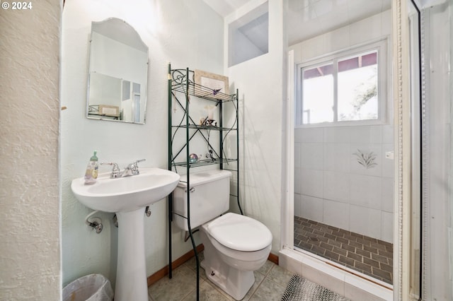 bathroom featuring walk in shower, tile flooring, sink, and toilet