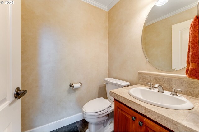 bathroom with crown molding, vanity, and toilet