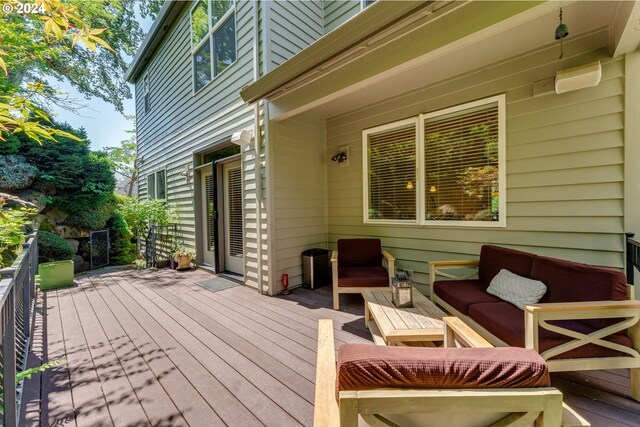 wooden deck with an outdoor living space