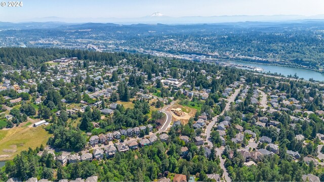 drone / aerial view with a water and mountain view