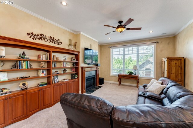 carpeted living room with crown molding, ceiling fan, and a fireplace