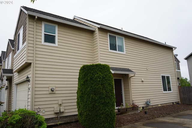 back of property featuring a garage