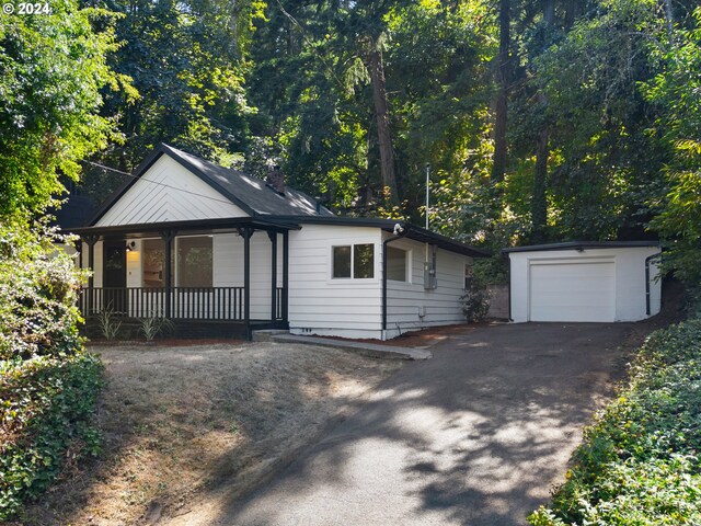 view of front of home with a garage, an outdoor structure, and a porch