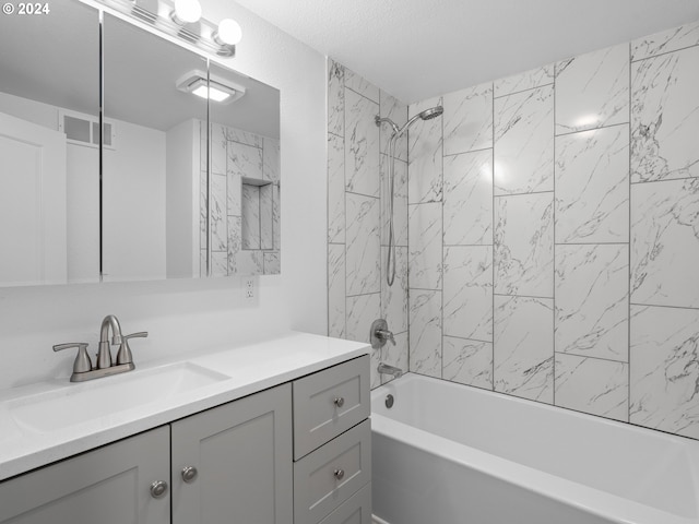 bathroom with vanity and tiled shower / bath combo