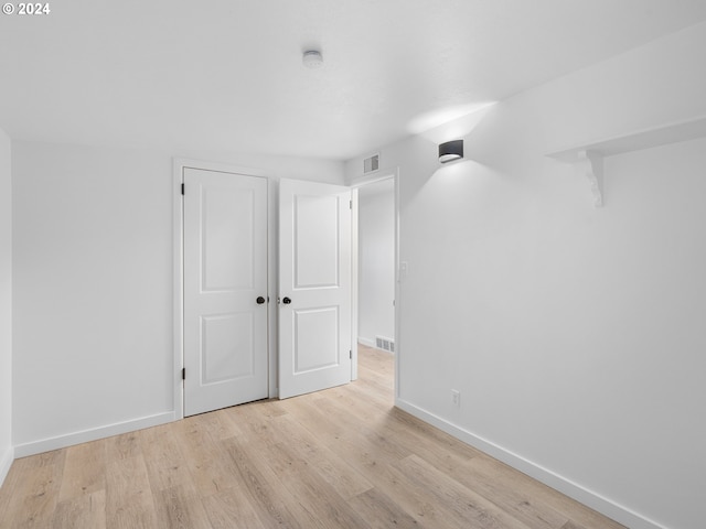 empty room with light hardwood / wood-style flooring