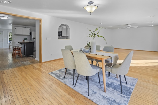 dining space featuring light hardwood / wood-style floors and ceiling fan