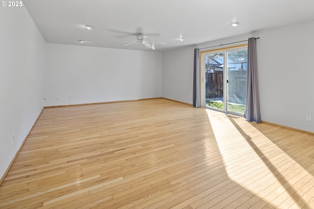 empty room with ceiling fan and light wood-type flooring