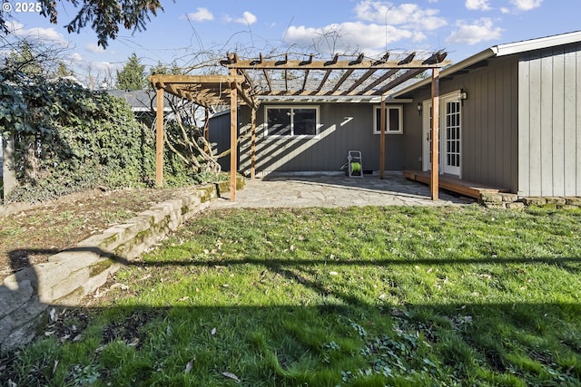 back of house featuring a pergola, a lawn, and a patio