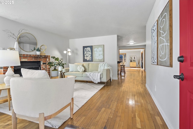 living room with a fireplace and light wood-type flooring