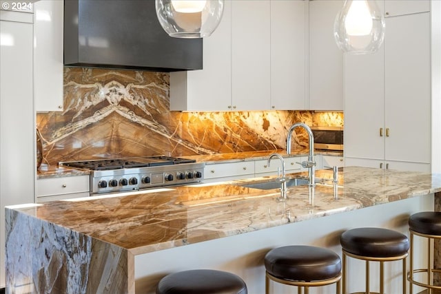 1933 Highlands Loop, Lake Oswego, OR 97034 - kitchen featuring light stone counters, stove, extractor fan, white cabinets, and decorative backsplash