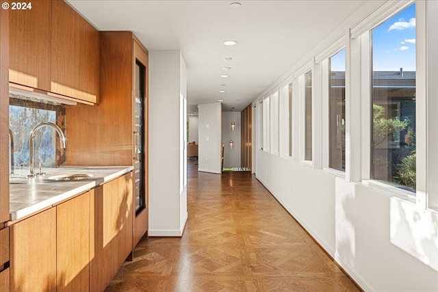 hall with light parquet flooring and sink