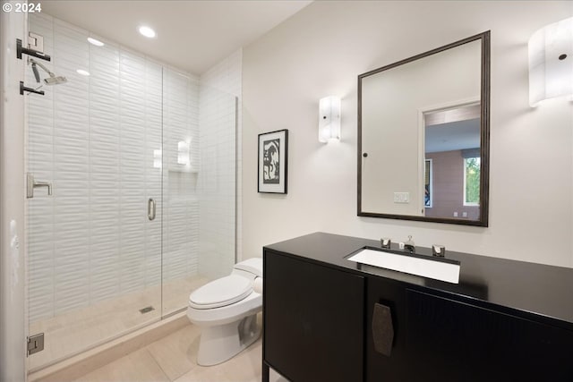 bathroom featuring vanity, tile patterned flooring, toilet, and walk in shower