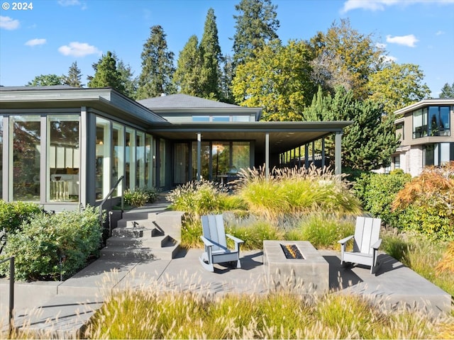 back of house featuring a fire pit