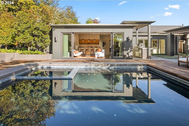 rear view of house featuring a pool side deck