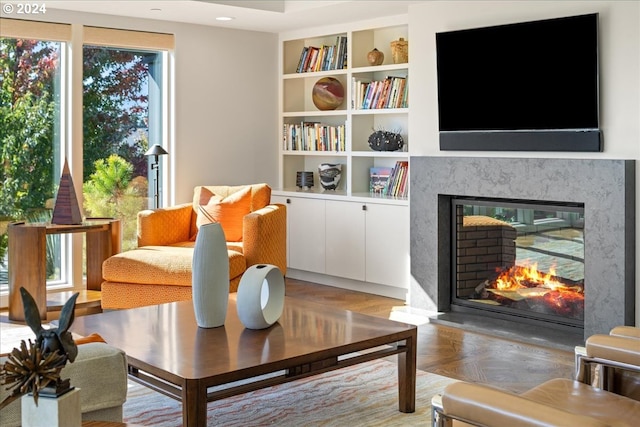 living area featuring a premium fireplace and parquet flooring