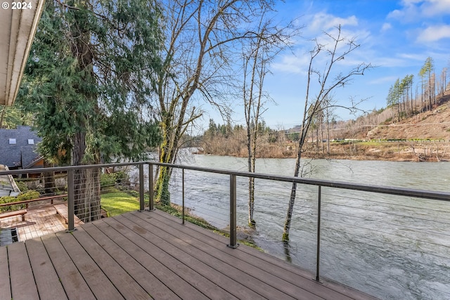 wooden terrace featuring a water view