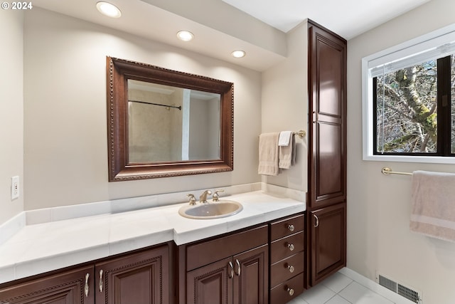 bathroom featuring tile patterned flooring and vanity