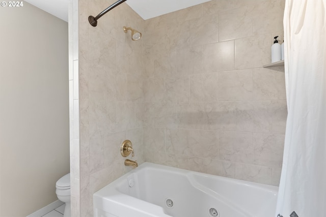 bathroom featuring tile patterned flooring, toilet, and shower / bath combo with shower curtain